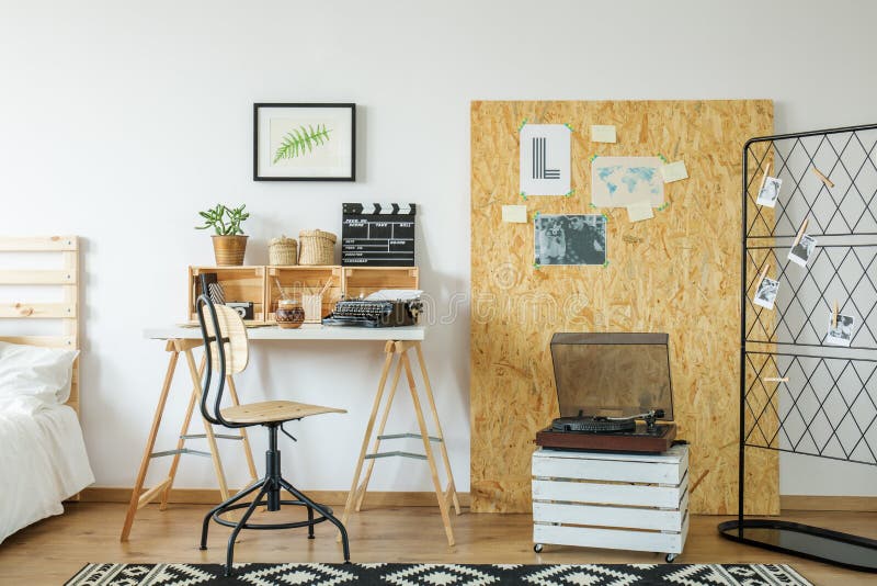 Room with desk and osb board. Modern light room with wooden desk and osb board with posters royalty free stock photography